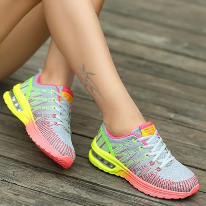 Graue Damen-Sneaker mit neonfarbenen Akzenten, atmungsaktiv, ideal für Sport und Freizeit.