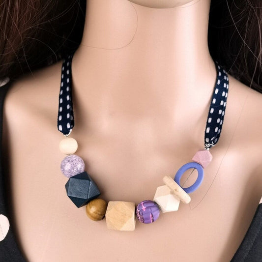 Bunte Halskette mit geometrischen Holzperlen und Stoffband, handgefertigter Schmuck.