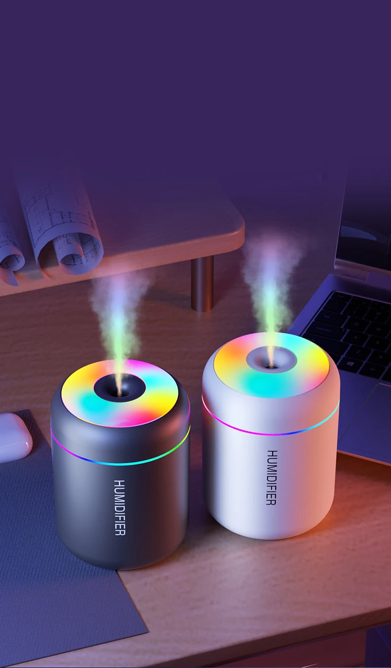 Zwei bunte LED-Luftbefeuchter auf Schreibtisch, schwarz und weiß, mit Dampf und Farbwechsel.