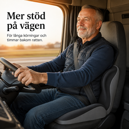 Man med grånande skägg kör lastbil med sittdynan i förarstolen bakom ryggen 5
