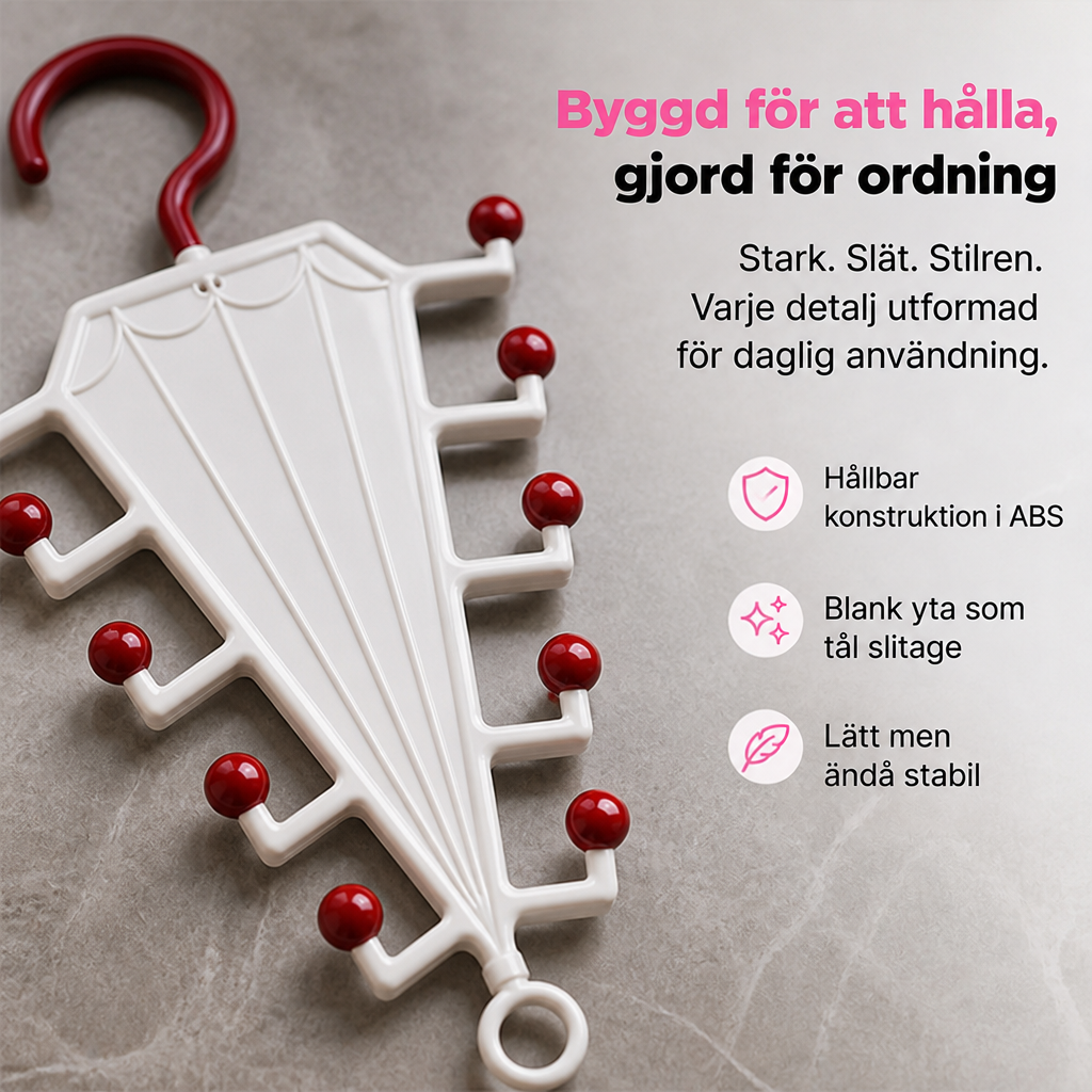 Närbild på vit galgstång med mörkröda kulspetsar och krok, liggande på en grå stenyta 3