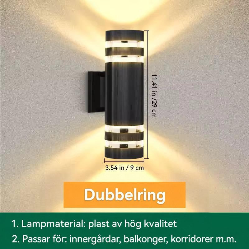 Måttbild av cylindrisk vägglampa med dubbla ljusband upptill och nedtill, höjd och diameter angivna 14