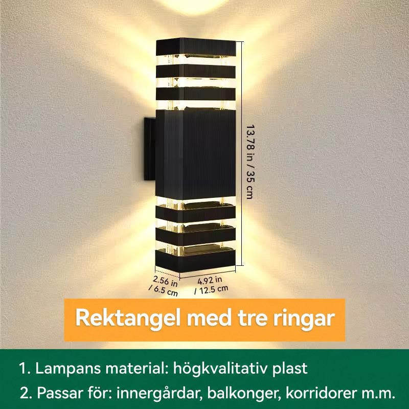 Måttbild av rektangulär vägglampa med tre ljusband upptill och nedtill, höjd, bredd och djup angivna 18