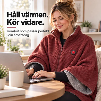 Kvinna i röd poncho med dragkedja skriver på laptop vid ett runt bord 11