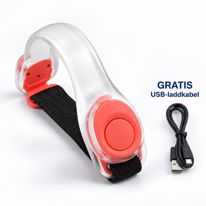Genomskinligt LED-armband med röda detaljer och svart elastiskt band, med medföljande USB-laddsladd bredvid 1