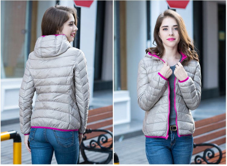 Frau in grauer Daunenjacke mit pinkem Reißverschluss, modisch, outdoor, Herbstmode.