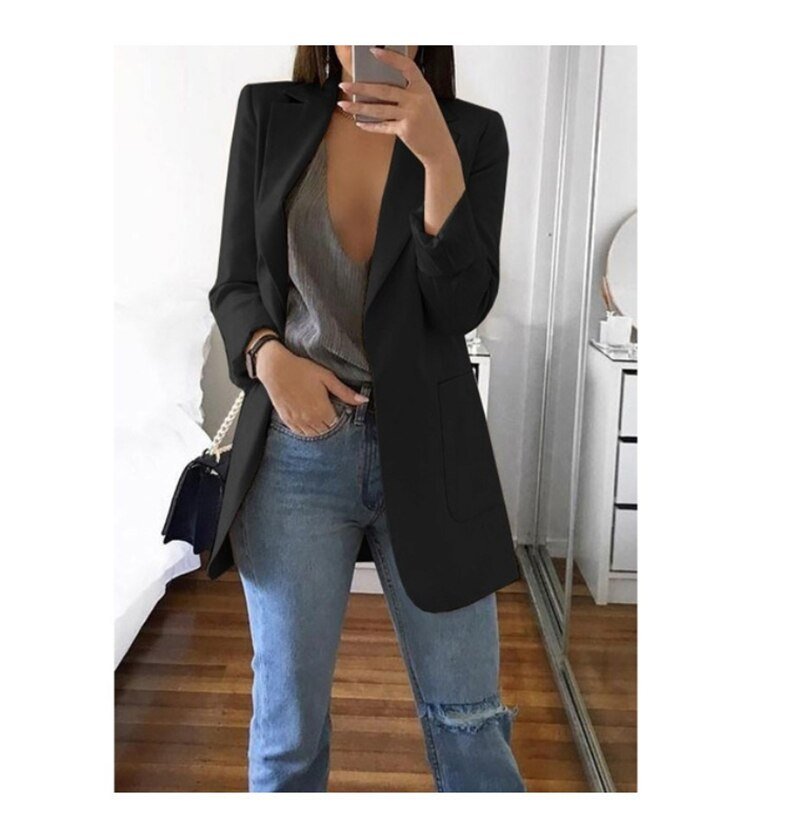 Frau in schwarzem Blazer, grauem Top und Jeans, modischer Frühlingslook, Spiegel-Selfie.