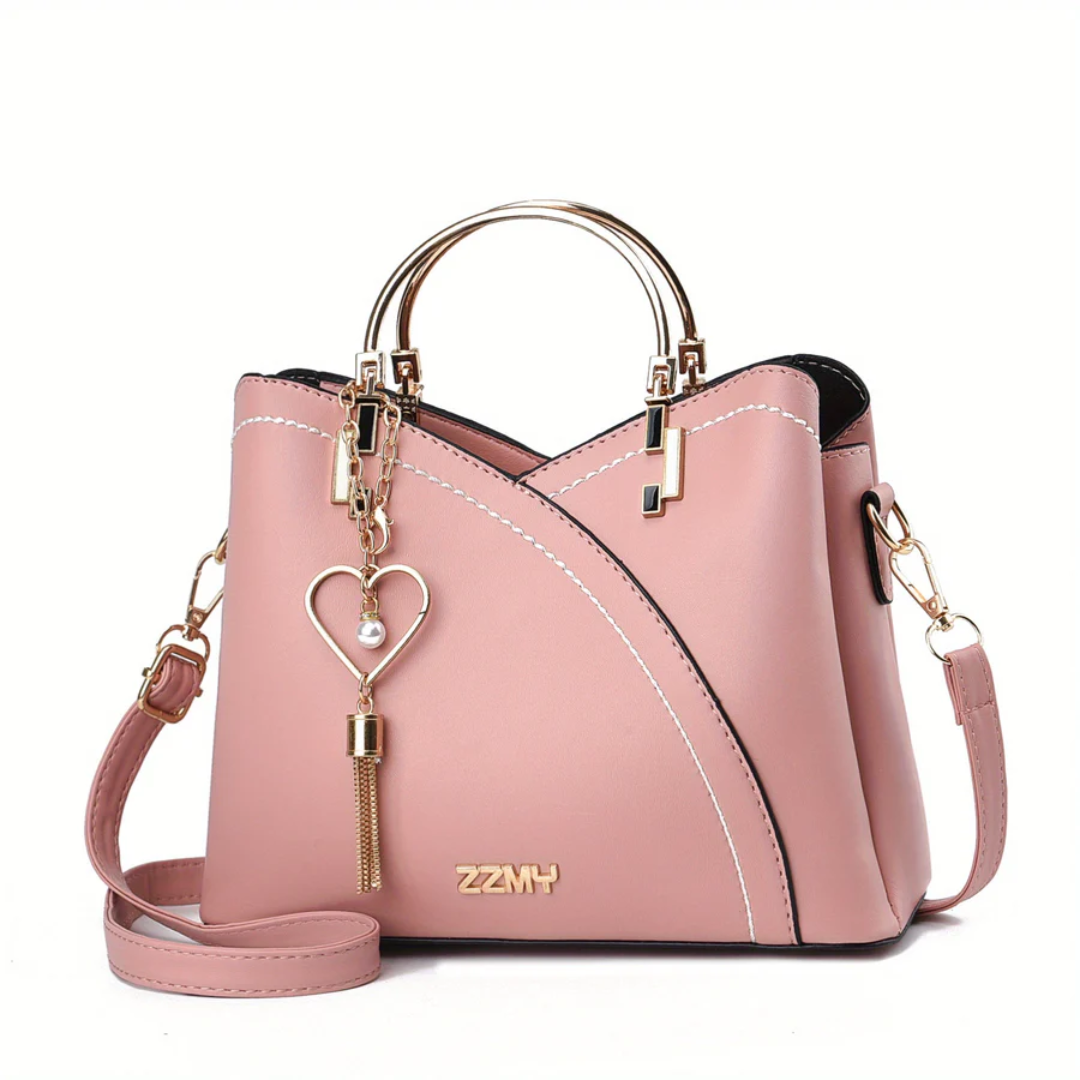 Rosa Damenhandtasche aus Leder mit Herzanhänger, goldene Details, modisch, elegant.