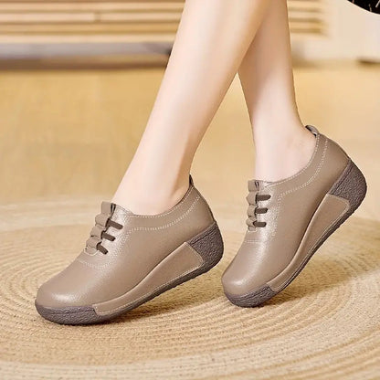 Beige Damen-Sneaker aus Leder mit Keilabsatz, bequem und modisch, ideal für den Alltag.