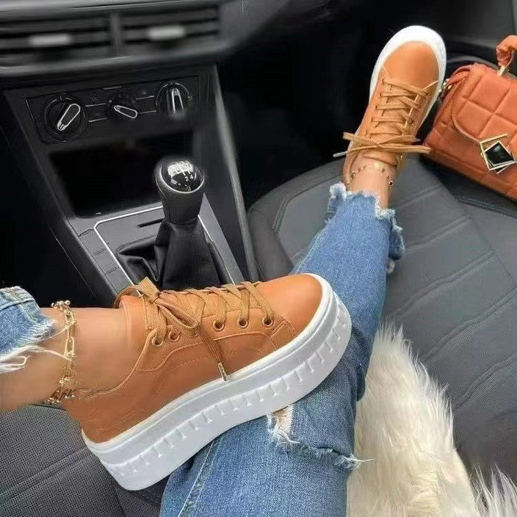 Damen Sneaker braun mit weißer Sohle, lässig, modisch, im Auto, zerrissene Jeans, Handtasche.