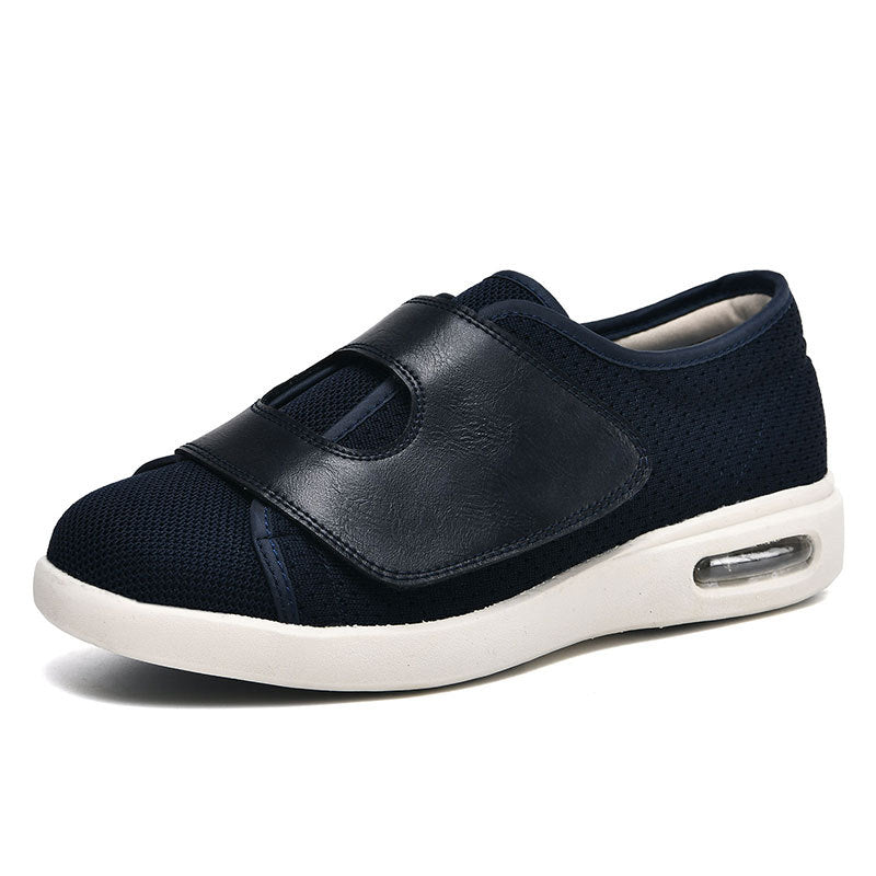 Dunkelblauer orthopädischer Schuh mit Klettverschluss und weißer Sohle für Damen.