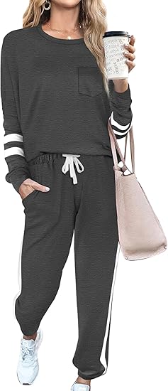 Frau in grauem Jogginganzug mit Kaffeebecher und rosa Tasche, sportlich, lässig, bequem.