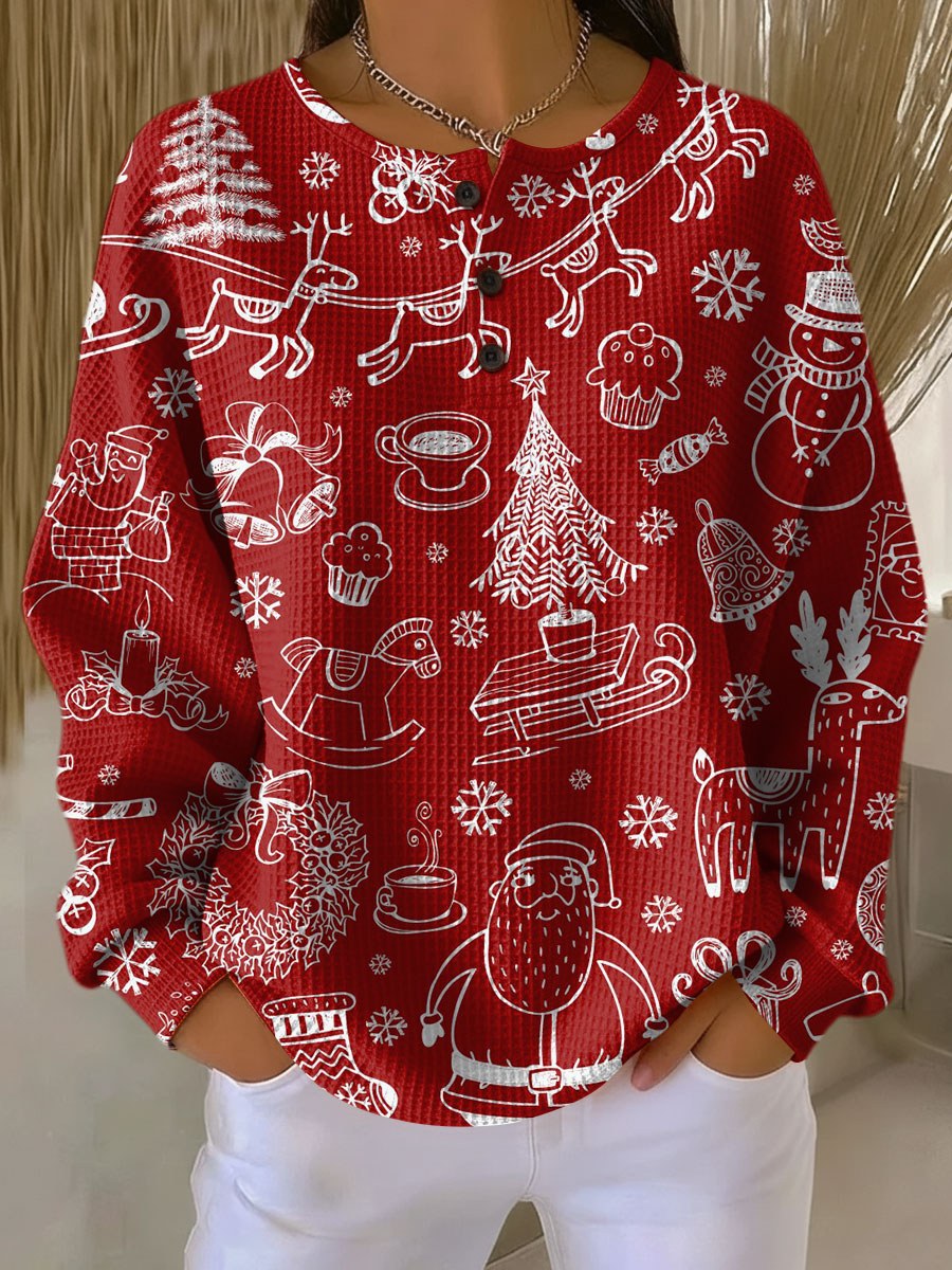 Röd våffelstickad tröja med knappslå, bärs av modell, täckt av vitt julmönster med tomte, renar, klockor, granar och snöflingor. 21
