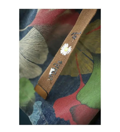 Bestickter Stoffbeutel mit Blumenmuster, brauner Träger, nachhaltige Mode, Damenaccessoire.