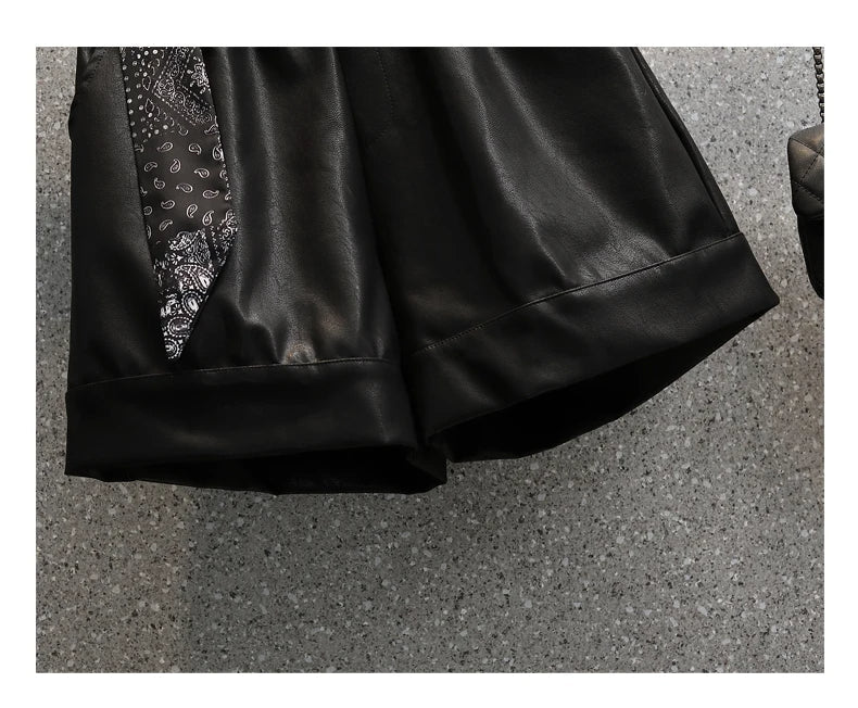 Schwarzer Lederrock mit Paisley-Muster, elegantes Design, Damenmode, Detailansicht.