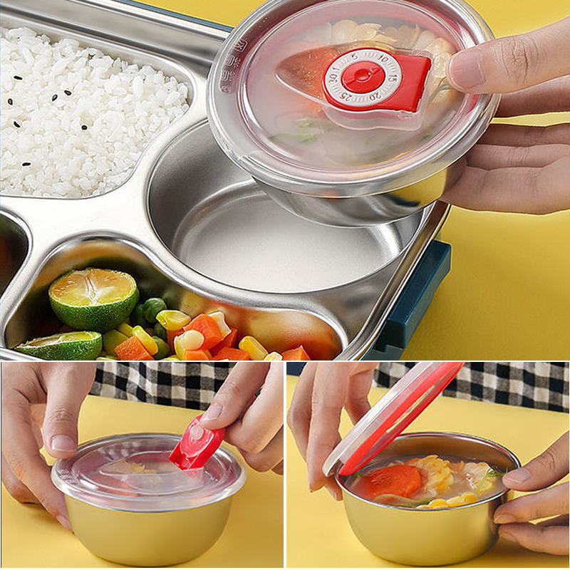 Edelstahl Brotdose mit Fächern, Deckel und Timer, ideal für Bento, gelber Hintergrund.