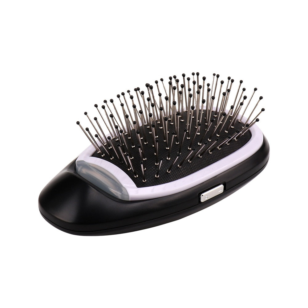 Schwarze elektrische Haarbürste mit Metallborsten, batteriebetrieben, für glattes Haarstyling.