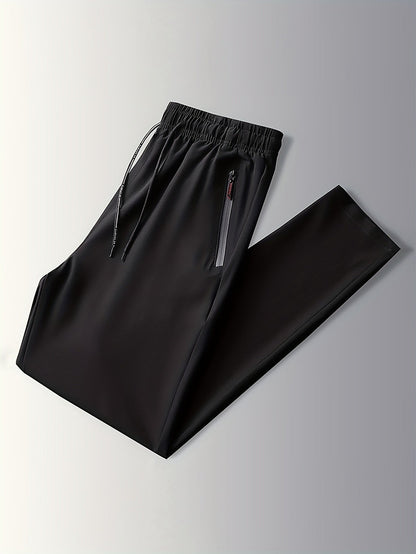 Schwarze Jogginghose mit Reißverschlusstaschen, elastischem Bund, Sportbekleidung Herren.