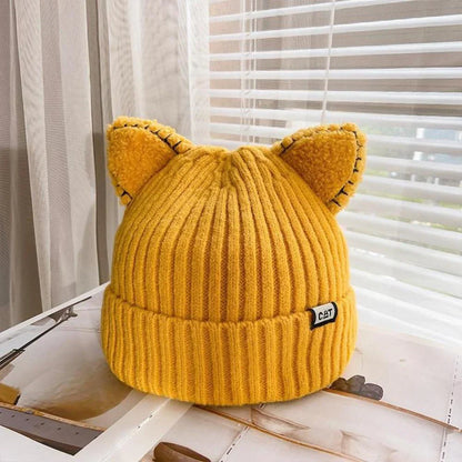 Gelbe Strickmütze mit Katzenohren, Damenmode, Winteraccessoire, warm, stilvoll, trendig.