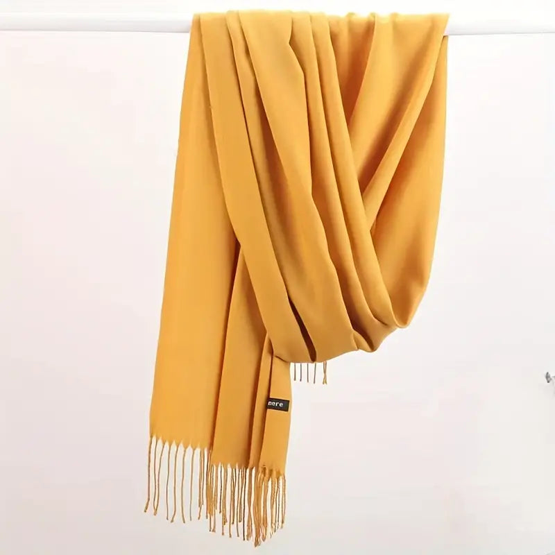 Gelber Kaschmirschal mit Fransen, weiches Material, modisches Accessoire für Herbst und Winter.