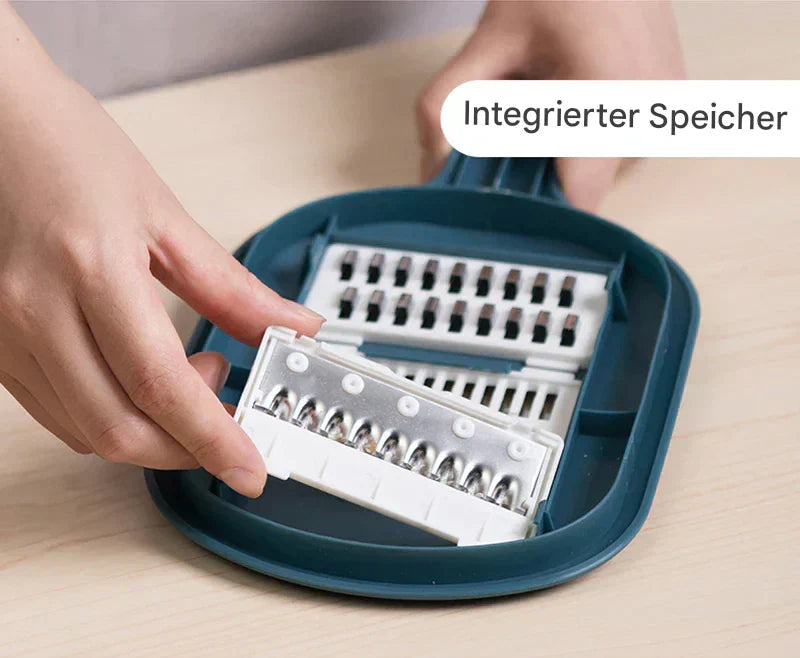 Hand hält blauen Gemüseschneider mit austauschbaren Klingen, integrierter Speicher.