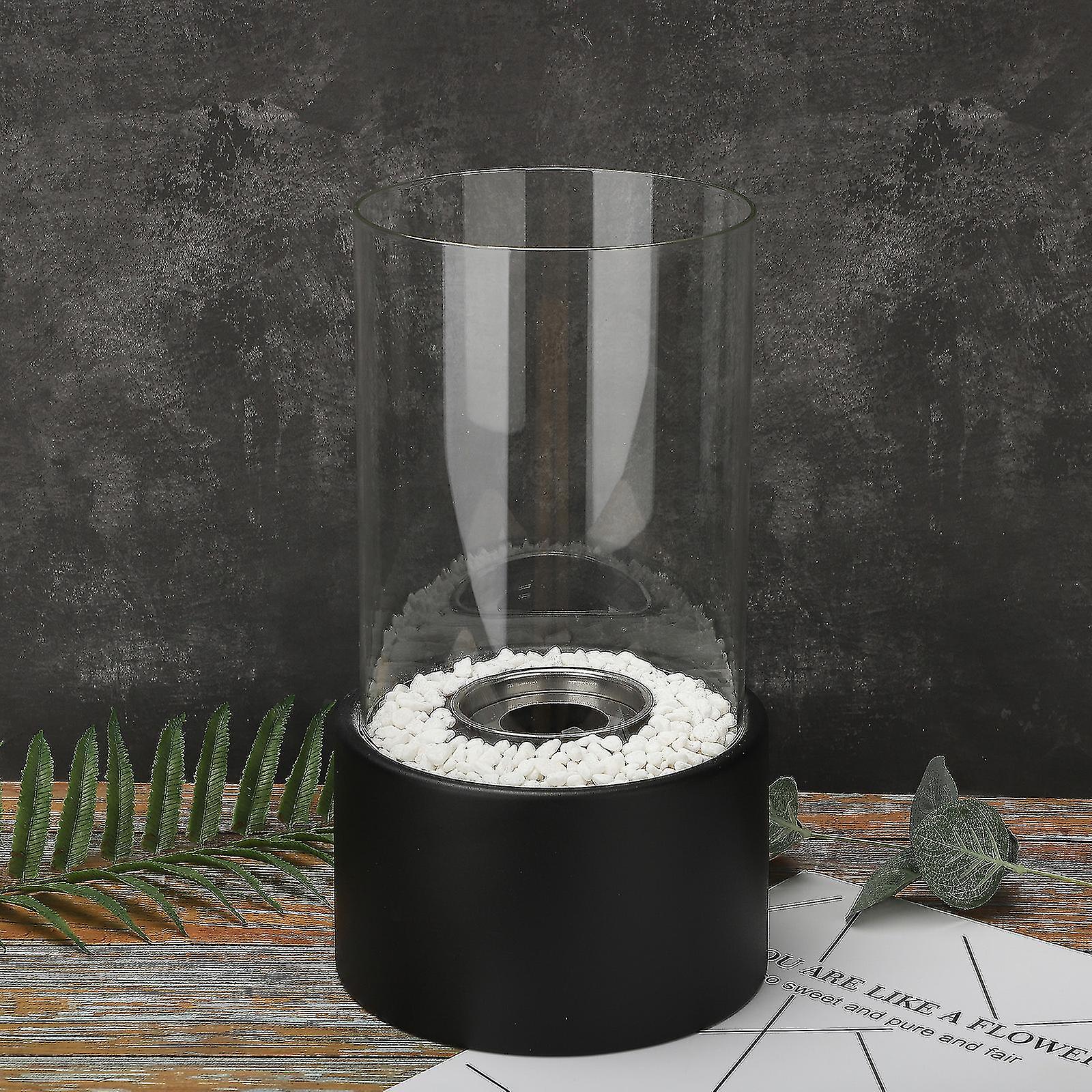 Moderne schwarze Öllampe mit Glaszylinder und weißen Steinen, dekorativ, Tischdekoration.