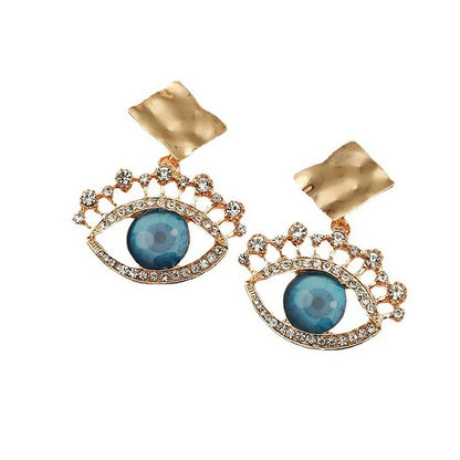 Goldene Ohrringe mit blauem Auge, Strasssteinen, modisches Schmuckdesign, Damenaccessoire.