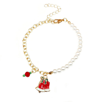 Goldenes Armband mit Perlen, rotem Weihnachtsglocken-Anhänger, festlicher Schmuck.
