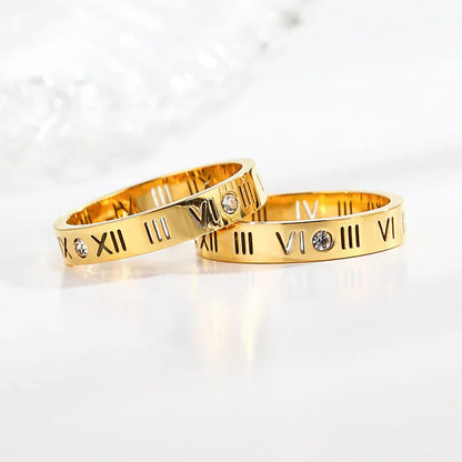 Zwei goldene Ringe mit römischen Ziffern und Diamanten, Eheringe, Schmuck, Luxusaccessoire.