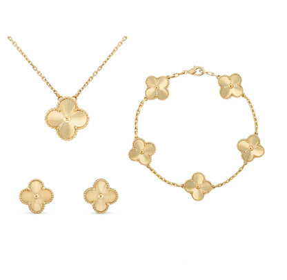 Goldene Schmuckset mit Blumenmotiv: Halskette, Armband, Ohrringe aus vergoldetem Metall.