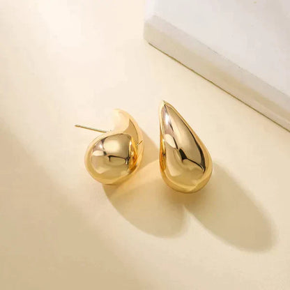 Goldene Tropfen-Ohrringe, glänzend, modisch, Schmuck für Damen, elegantes Design.