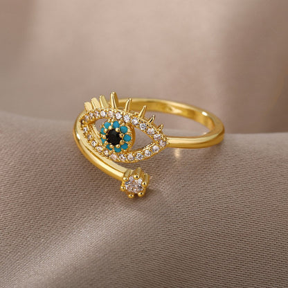 Goldener Ring mit Auge-Design, Zirkonia-Steinen, türkisfarbenen Akzenten, modischer Schmuck.