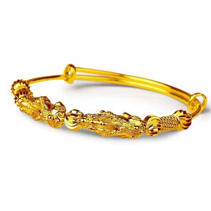Goldenes Armband mit Drachenmotiv, verstellbar, aus Metall, elegantes Schmuckstück.