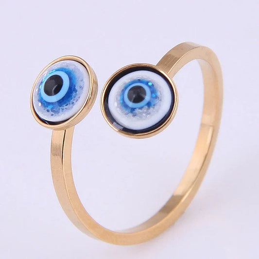 Goldener Ring mit zwei blauen Augen-Designs, modisches Schmuckstück, Damenaccessoire.