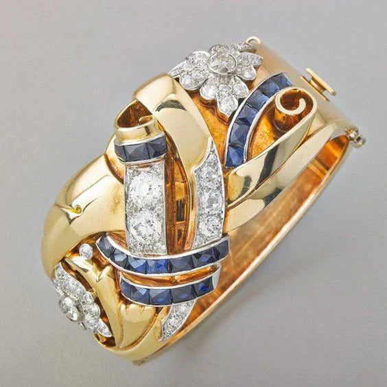 Goldenes Armband mit Diamanten und blauen Saphiren, florales Design, luxuriöser Schmuck.