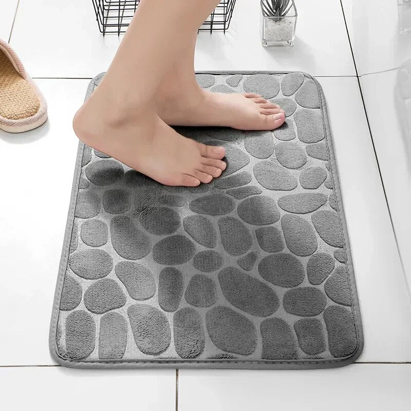 Grauer rutschfester Badematte aus Mikrofaser, Steinoptik, Badezimmer, Füße, Fliesenboden.