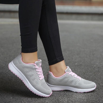 Graue Damen-Sneaker mit rosa Akzenten, atmungsaktiv, ideal für Freizeit und Sport.