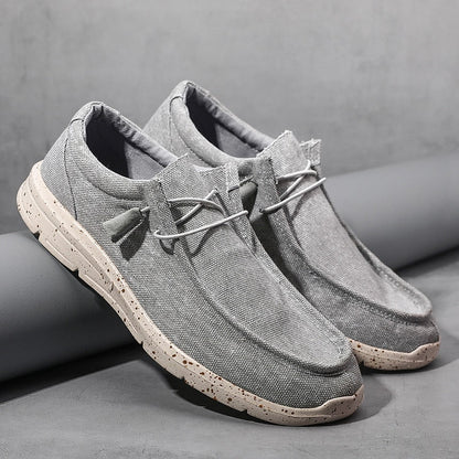 Graue Herren-Sneaker aus Leinen, lässig, mit weißer Sohle, ideal für Freizeitkleidung.