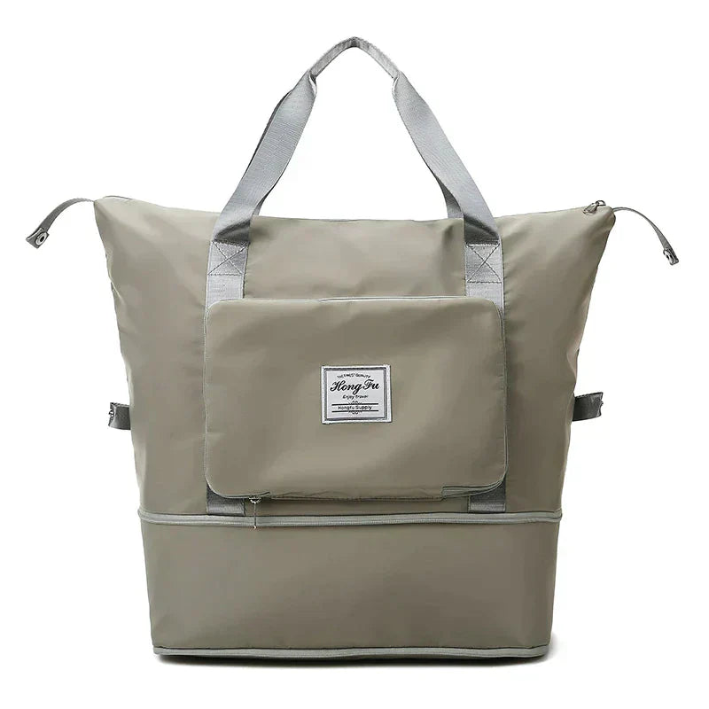 Graue Reisetasche mit Reißverschluss, großer Fronttasche, robustem Material, ideal für Reisen.