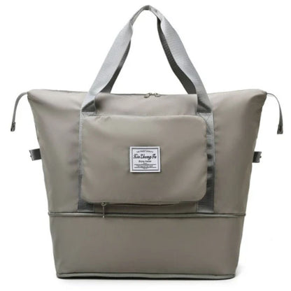 Graue Reisetasche mit Reißverschluss, robustem Stoff, großem Hauptfach und Tragegriffen.