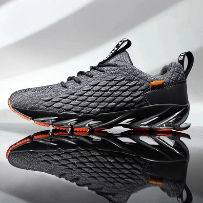 Grauer Sportschuh mit orangen Akzenten, atmungsaktives Mesh, rutschfeste Sohle, Herren Sneaker.