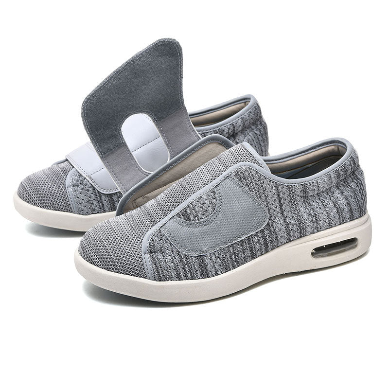 Graue orthopädische Schuhe mit Klettverschluss, atmungsaktiv, bequem, für Damen und Herren.
