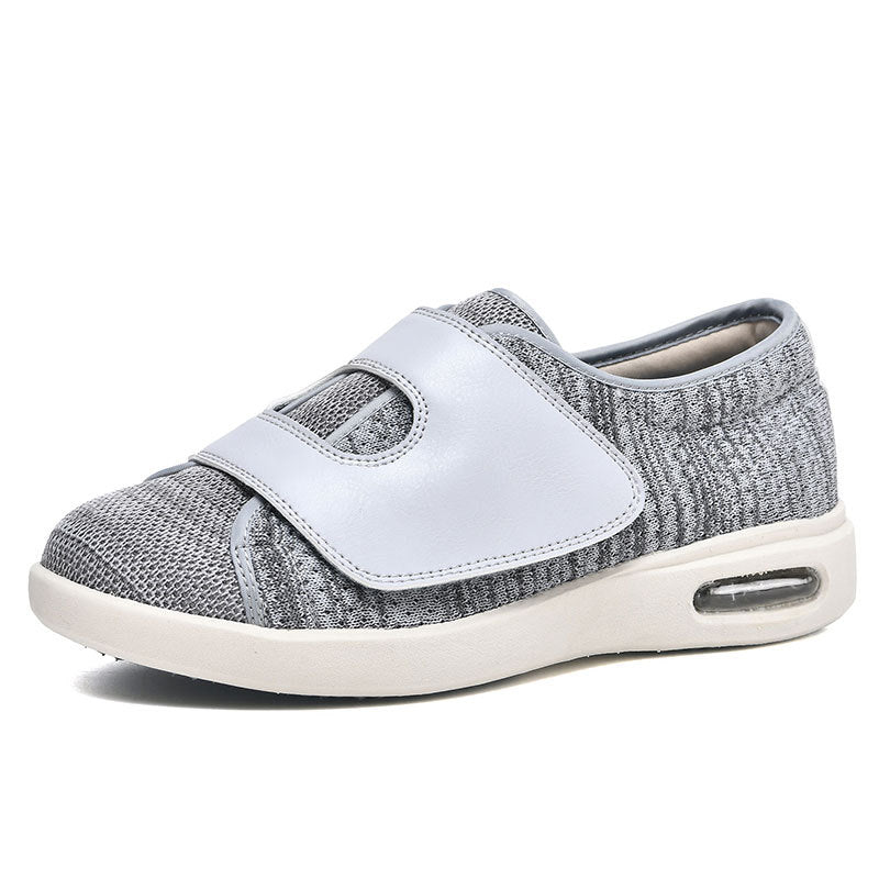 Grauer orthopädischer Schuh mit Klettverschluss, atmungsaktiv, bequem, für Damen und Herren.