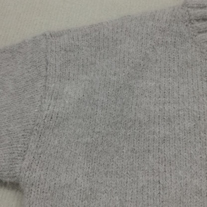 Grauer Strickpullover aus Wolle, Nahaufnahme, weiches Material, modisch, warm, Winterkleidung.