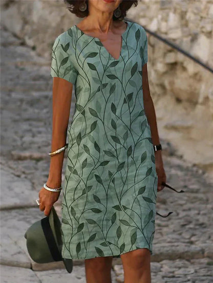 Grünes Sommerkleid mit Blattmuster, V-Ausschnitt, kurzärmelig, Damenmode, lässig.