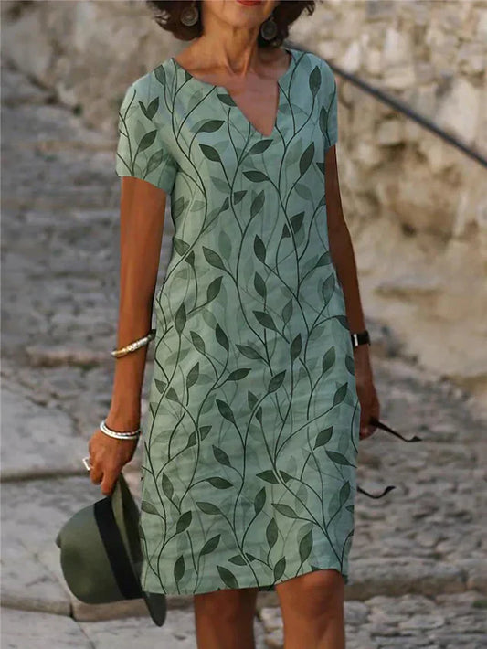Grünes Sommerkleid mit Blattmuster, V-Ausschnitt, kurzärmelig, Damenmode, lässig.