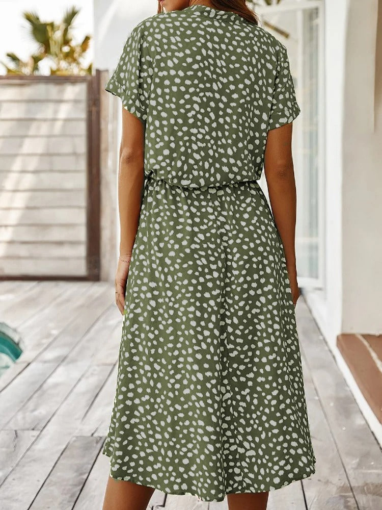 Grünes Sommerkleid mit weißen Punkten, knielang, kurzärmelig, ideal für Freizeitmode.