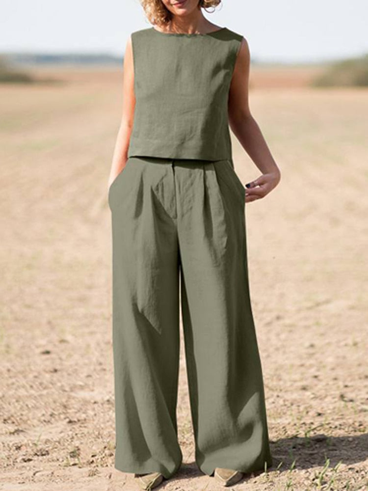 Frau in olivgrünem Leinen-Zweiteiler, ärmelloses Oberteil, weite Hose, Sommermode.
