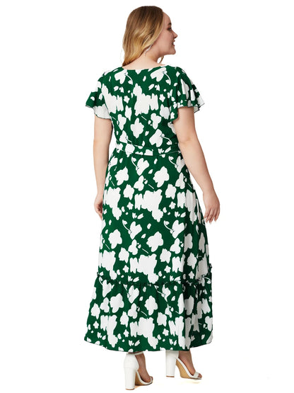 Frau im grünen Maxikleid mit weißem Blumenmuster, kurze Ärmel, Rückansicht, Sommermode.