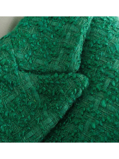 Grüner Bouclé-Stoff, Textur, weiches Material, ideal für Mode und Heimtextilien.